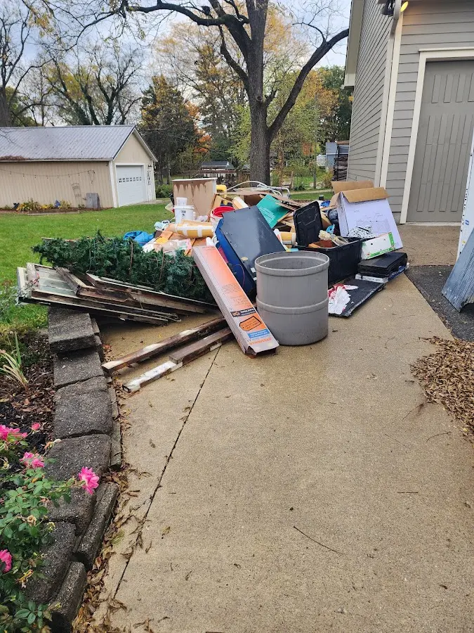 Dumpster being loaded with debris for Commercial Dumpster Rental in Rehoboth